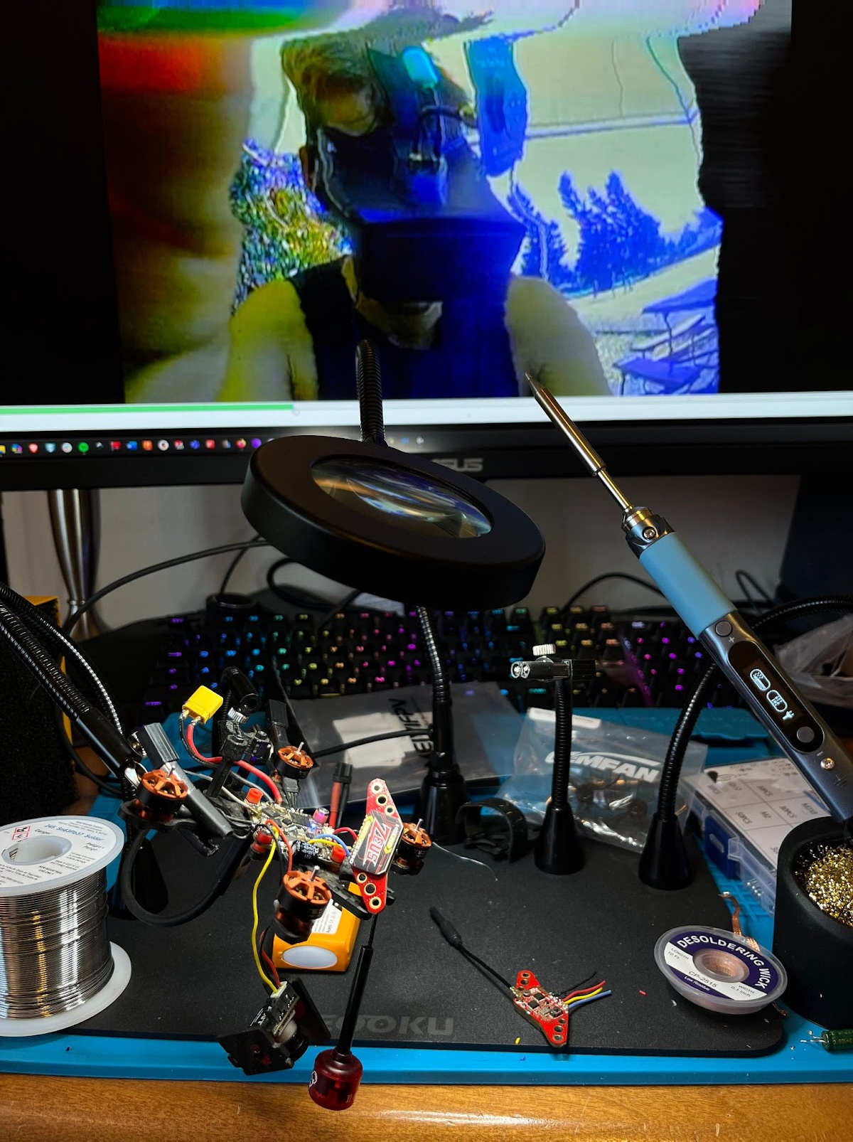 An FPV racing drone being repaired at Peter's electronics workbench