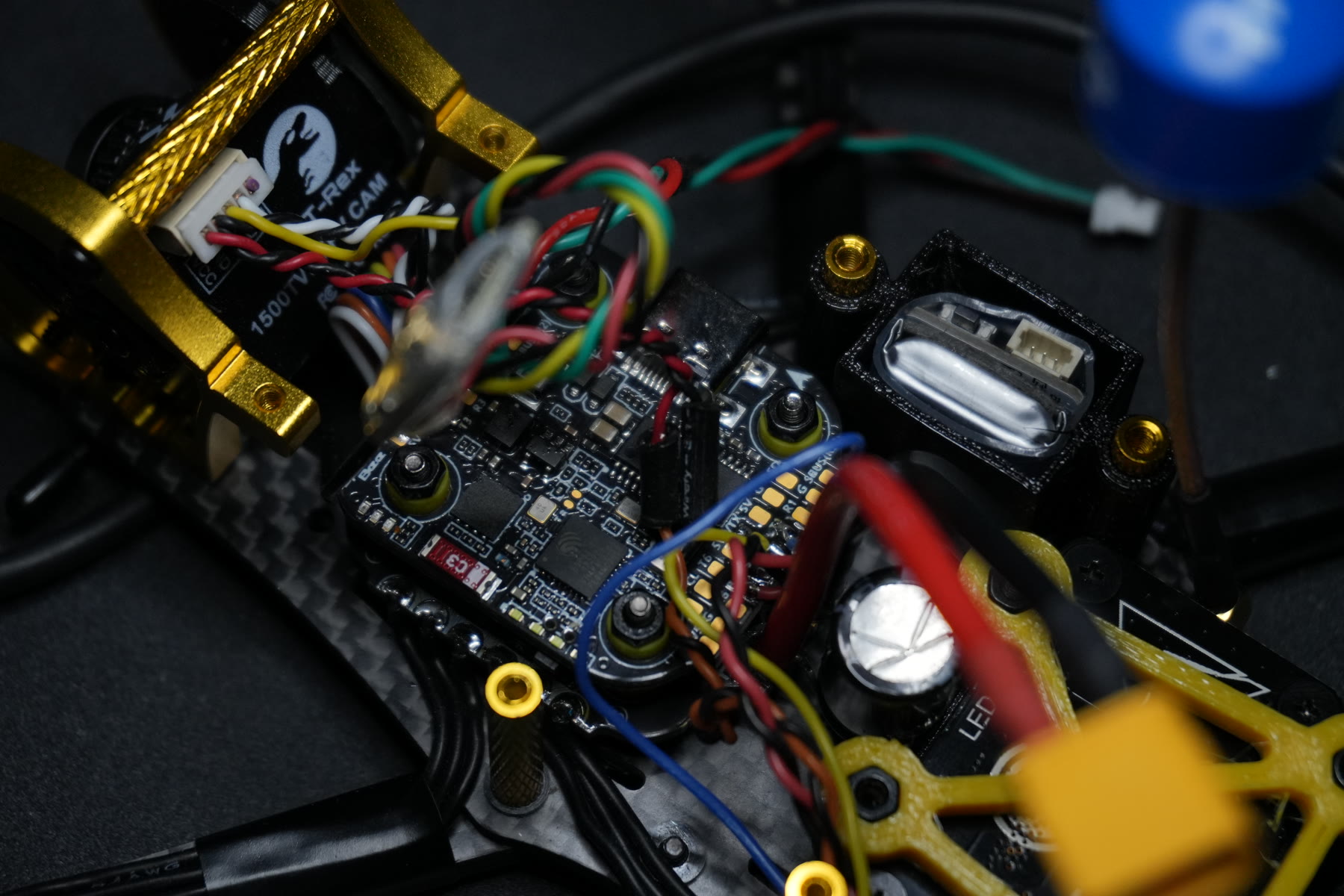 Close-up of the electronics and custom hardware inside Peter's Blue Dragon FPV racing drone